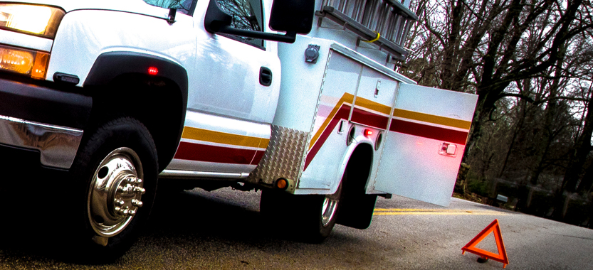 Photo shows an emergency vehicle parked on side of the road