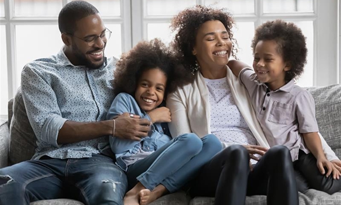 Happy black family in the living room.