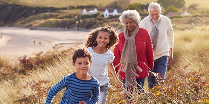 Two kids walking with their grandpas
