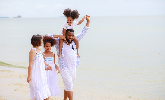 Family of four walking at the beach