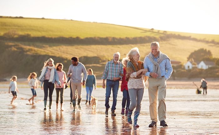 Multi generational family walking on the beach