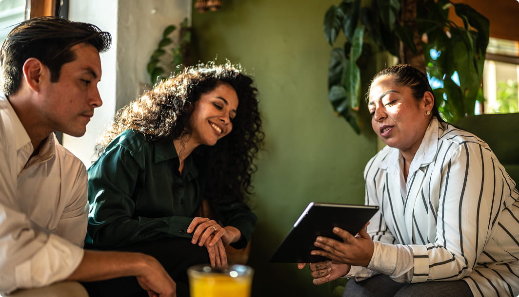 An insurance agent explains policy options to a young couple