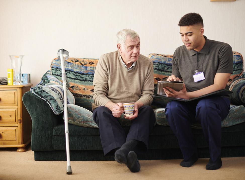 Older patient being educated by caregiver.