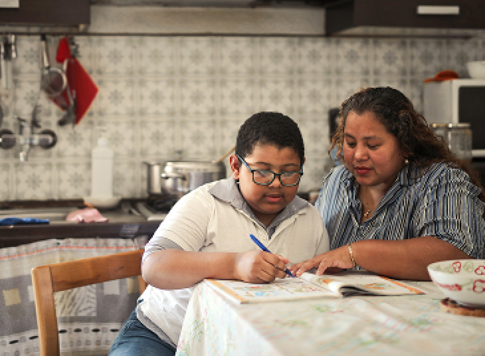 Mother helping child with homework