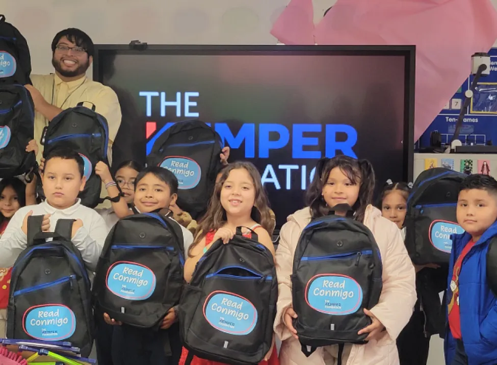 Students display Read Conmigo backpacks provided by The Kemper Foundation in their classroom