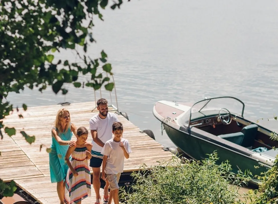 Family walking on a boat dock