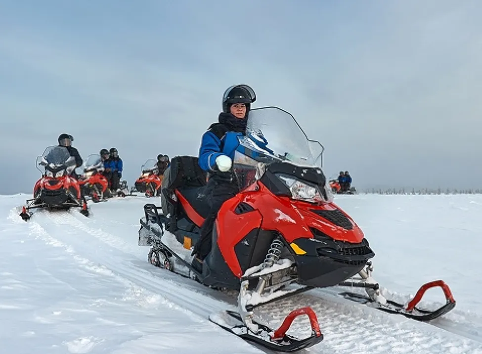 People riding a snowmobile