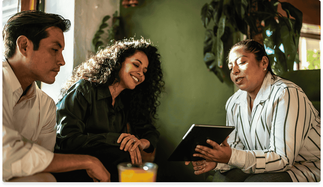 An insurance agent explains policy options to a young couple